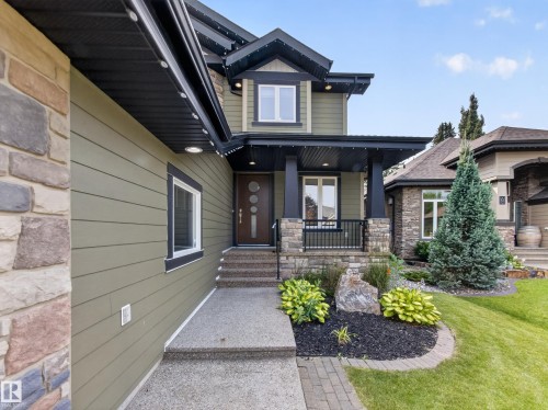 Contemporary exterior featuring olive-green siding and stacked stone accents - #59 10550 Ellerslie Rd Sw, Edmonton, AB - Outdoor With Deck Patio Veranda
