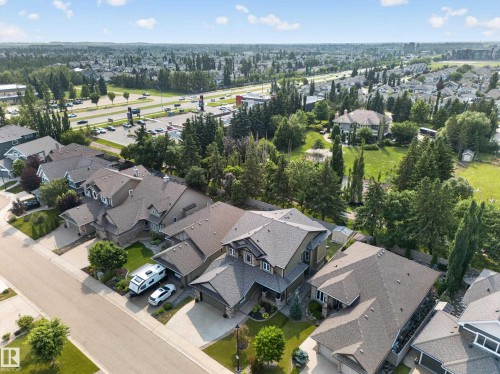 Residential street featuring a row of single-family homes with pitched roofs and attached garages - #59 10550 Ellerslie Rd Sw, Edmonton, AB - Outdoor With View