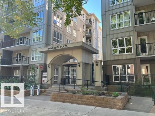 Modern multi-story building featuring multiple balconies, a covered arched entryway, and integrated landscaping planters - #407 11103 84 Av Nw, Edmonton, AB 