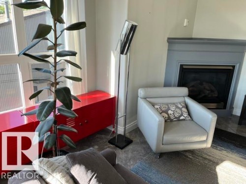 Fireplace with a painted mantel - #407 11103 84 Av Nw, Edmonton, AB 