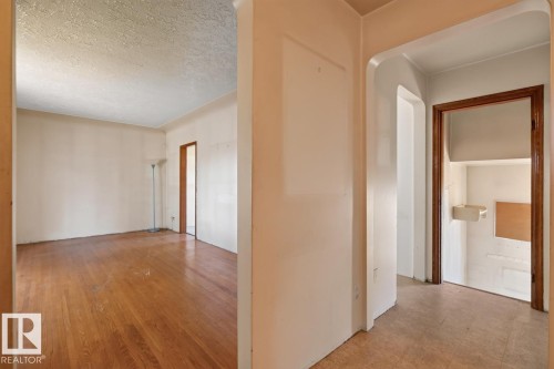 Hardwood flooring, arched doorway, exposed wood door frame, built-in wall shelf - 12309 128 Street Nw, Edmonton, AB 