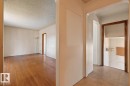 Hardwood flooring, arched doorway, exposed wood door frame, built-in wall shelf - 12309 128 Street Nw, Edmonton, AB 