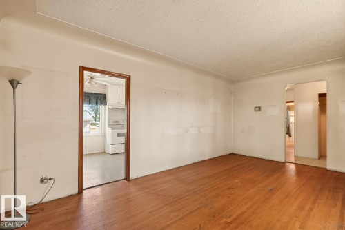 Wood-finish flooring with white walls and natural light - 12309 128 Street Nw, Edmonton, AB 