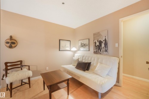 Light-toned wood-finish flooring complements neutral wall tones - #203 10171 119 St Nw, Edmonton, AB 
