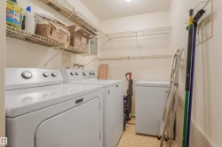 Dedicated laundry area featuring wire shelving, a washer, and a dryer - 