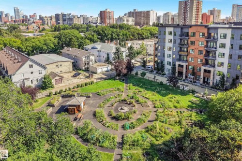 Landscaped communal garden with winding paths, a central gazebo, and various plantings - #203 10171 119 St Nw, Edmonton, AB 