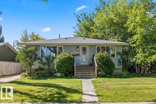 Ranch-style residence featuring light blue siding and a shingle roof - 10990 135 Street Nw, Edmonton, AB 