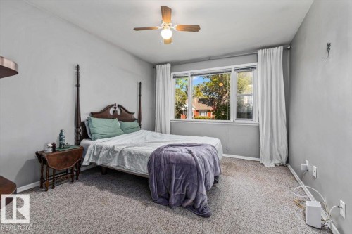 Broadloom carpeting, overhead ceiling fan with lighting, and multiple windows - 10990 135 Street Nw, Edmonton, AB 
