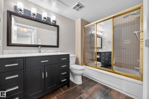 4 Piece Bathroom featuring dark cabinets, quartz counters, and bathtub/shower combo. - #803 10011 123 St Nw, Edmonton, AB 