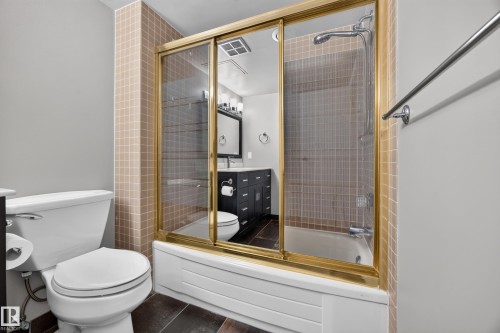 4 Piece Bathroom featuring dark cabinets, quartz counters, and bathtub/shower combo. - #803 10011 123 St Nw, Edmonton, AB 