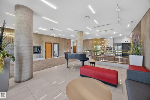 Lobby of the Condo Building featuring seating area, grand piano, mailboxes, and on site manager office. - #803 10011 123 St Nw, Edmonton, AB 