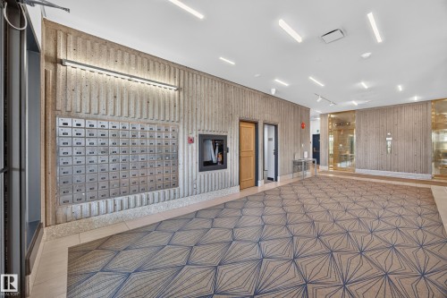 Lobby of the Condo Building featuring seating area, grand piano, mailboxes, and on site manager office. - #803 10011 123 St Nw, Edmonton, AB 