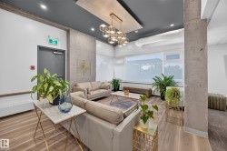 Condo Building Social Room Space featuring Kitchen, Dining Room Space, Multiple Lounge Spaces, two Bathrooms, and access to outdoor common space. - 