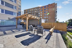 Condo Building Outdoor Common Space featuring Resident BBQ Area, Gazebo, Sitting Areas, Beautiful Landscaping, and Stunning River Valley views. - 