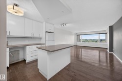 White kitchen featuring quartz counters, hardwood flooring, electric stove, microwave hood fan, space for a dishwasher, and refrigerator. - 