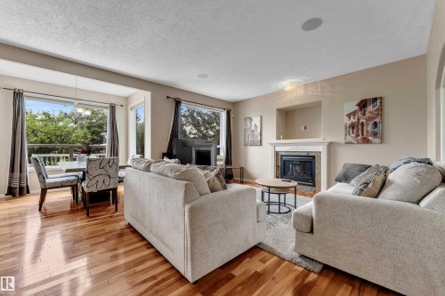 Hardwood flooring, bay window, built-in fireplace, recessed ceiling lighting, and a built-in media niche - 1226 Mcallister Way Sw, Edmonton, AB 