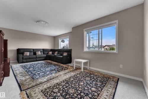 Recessed lighting, light-toned wall paint, large framed window, white trim - 1226 Mcallister Way Sw, Edmonton, AB 