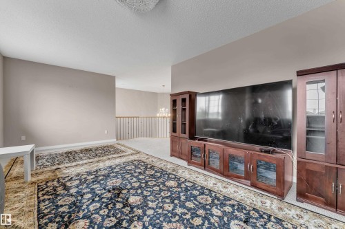 Neutral wall finishes, recessed lighting, and a chandelier fixture - 1226 Mcallister Way Sw, Edmonton, AB 