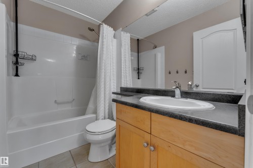 White bathtub and shower combination with a bright white shower curtain - 1226 Mcallister Way Sw, Edmonton, AB 