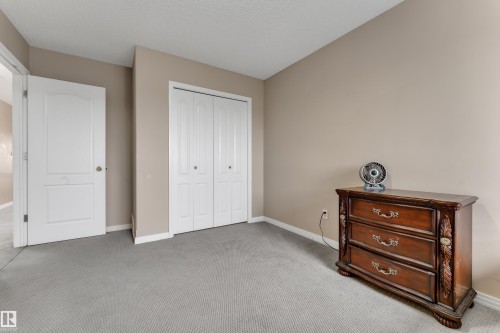 Neutral tone wall finish with a textured ceiling - 1226 Mcallister Way Sw, Edmonton, AB 