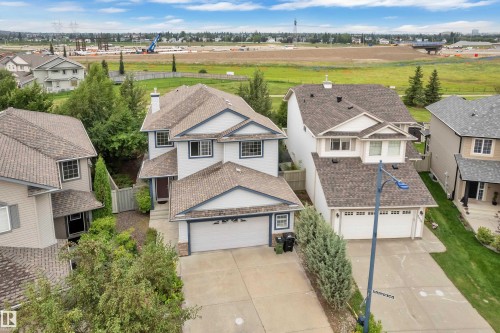 Two-story residence with attached garage, contrasting trim, and mature landscaping - 1226 Mcallister Way Sw, Edmonton, AB 