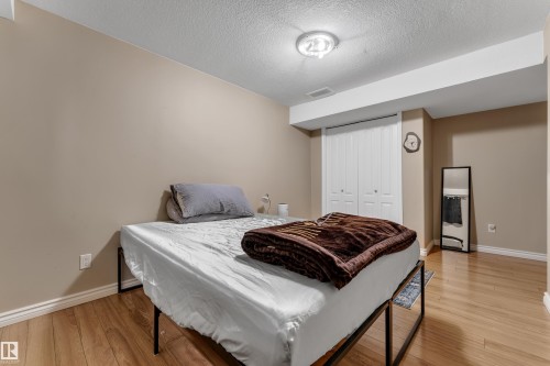 Recessed lighting, wood-finish flooring, neutral wall tones, bi-fold closet doors - 1226 Mcallister Way Sw, Edmonton, AB 