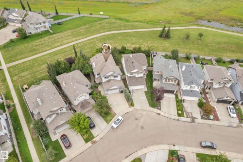 Residential neighborhood setting with multiple detached homes, paved streets, and green spaces - 1226 Mcallister Way Sw, Edmonton, AB 