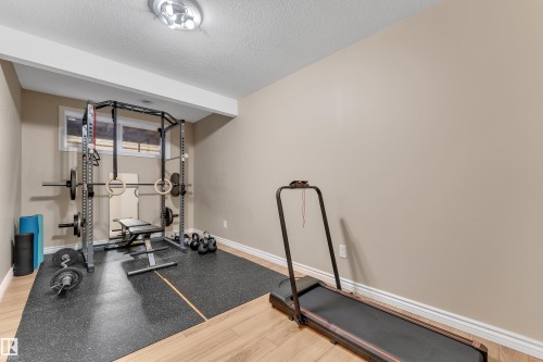 Recessed window, wood-finish flooring, and ceiling-mounted light fixture - 1226 Mcallister Way Sw, Edmonton, AB 