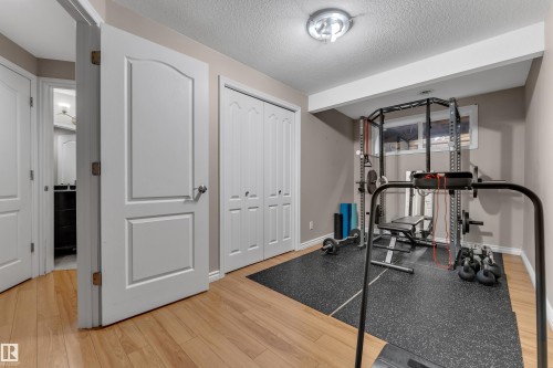 Light wood-finish flooring complements the neutral wall color - 1226 Mcallister Way Sw, Edmonton, AB 