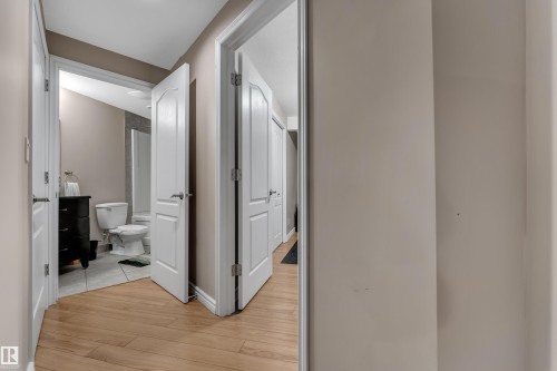 Wood-finish flooring throughout, with white interior doors and neutral wall colors - 1226 Mcallister Way Sw, Edmonton, AB 