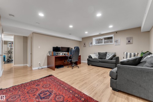 Recessed ceiling lighting, light wood-finish flooring, and a window with blinds - 1226 Mcallister Way Sw, Edmonton, AB 