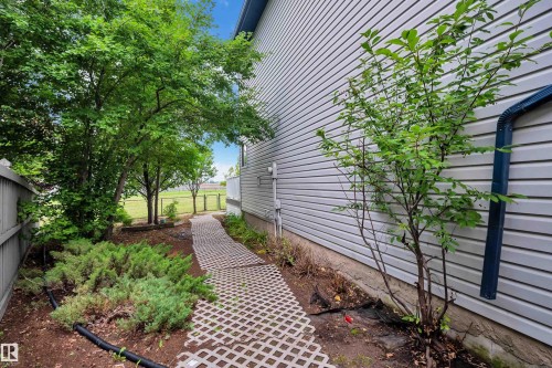 Siding exterior with a patterned paver pathway - 1226 Mcallister Way Sw, Edmonton, AB 