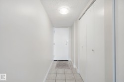 Entryway featuring light-toned tile flooring, flush-mount ceiling lighting, and multiple bi-fold closet doors - 