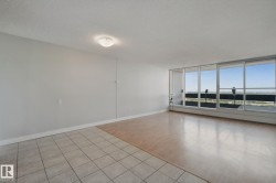 Expansive windows, wood-finish flooring, tiled flooring, neutral wall tones, and ceiling-mounted light fixture - 
