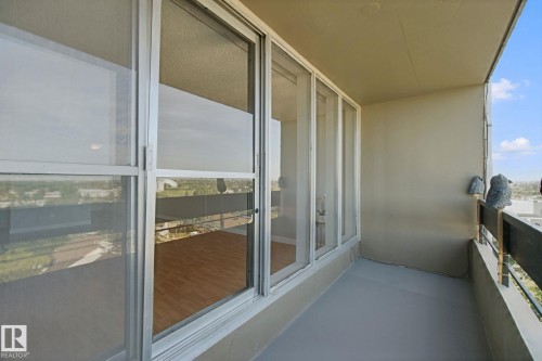 Balcony featuring a painted concrete floor and a metal railing - #104 8745 165 St Nw, Edmonton, AB 
