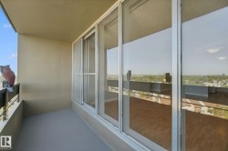 Balcony featuring a painted concrete floor, metal railing, and sliding glass doors - 