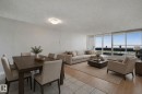 Open-concept living area with tile and wood-finish flooring - #104 8745 165 St Nw, Edmonton, AB 