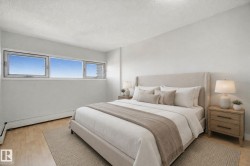 Light wood-finish flooring, white walls, and a multi-pane window configuration - 