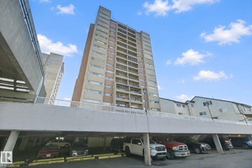 Multi-story residential building with private balconies and a ground-level parking structure - #104 8745 165 St Nw, Edmonton, AB 