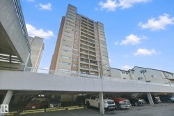 Multi-story residential building with private balconies and a ground-level parking structure - 
