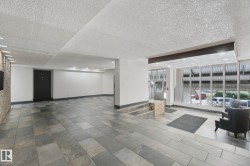 Spacious common area featuring large format tile flooring, recessed lighting, and a full-height window wall - 
