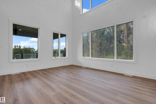 Vaulted ceilings featuring multiple windows and wood-finish flooring - 57 Meadowgrove Lane, Spruce Grove, AB - Indoor Photo Showing Other Room