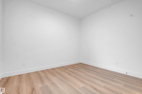 Room featuring wood-finish flooring, white walls, and white baseboards - 57 Meadowgrove Lane, Spruce Grove, AB - Indoor Photo Showing Other Room