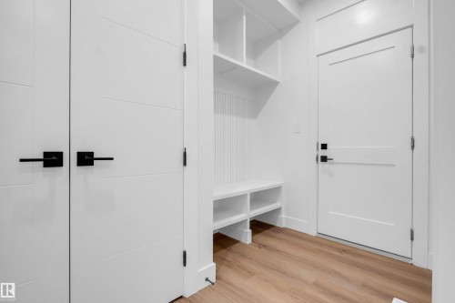 Entryway featuring wood-finish flooring and a built-in storage bench - 57 Meadowgrove Lane, Spruce Grove, AB - Indoor Photo Showing Other Room