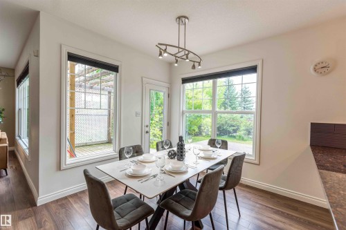 Wood-finish flooring, white walls, and a modern track lighting fixture - 5092 Thibault Way Nw, Edmonton, AB 