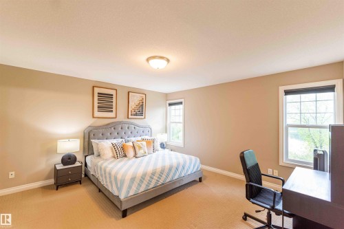Carpeted flooring, neutral wall tones, two windows with white trim, and a flush mount ceiling light fixture - 5092 Thibault Way Nw, Edmonton, AB 