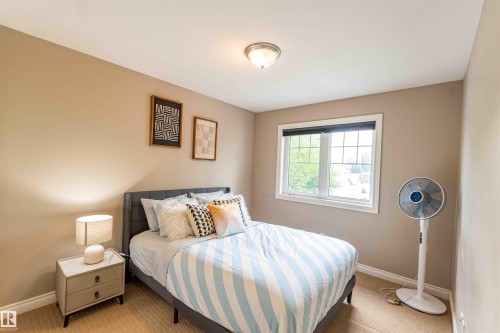 Recessed lighting, large window, neutral wall color, and textured carpet flooring - 5092 Thibault Way Nw, Edmonton, AB 