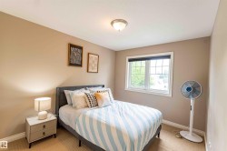 Recessed lighting, large window, neutral wall color, and textured carpet flooring - 