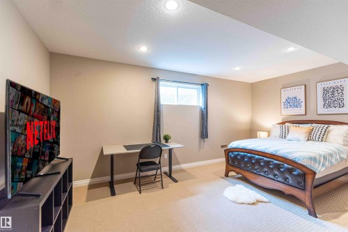 Recessed lighting, neutral wall paint, light-toned carpeting, and a window with blinds - 5092 Thibault Way Nw, Edmonton, AB 