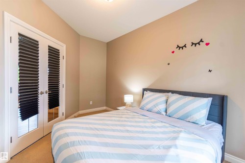 White French doors with louvered blinds, light beige wall paint, and recessed lighting - 5092 Thibault Way Nw, Edmonton, AB 